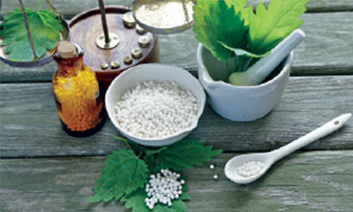 Picture of Homeopathic medicine used in dental work at Premier Holistic Dental in beautiful Costa Rica.  The picture shows a bowl and a bottle with Homeopathic medicine.
